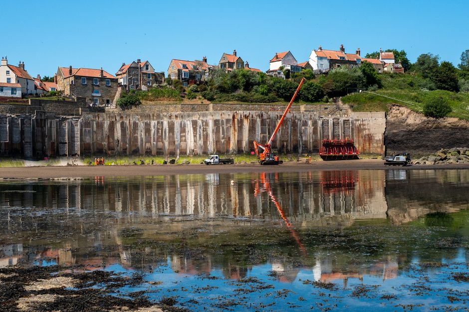 Crane and sea wall construction at Robin Hood's Bay, England.